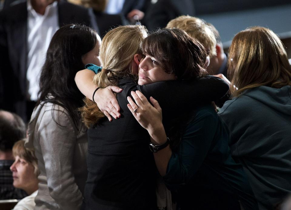 Residents greet each other before an interfaith vigil for the victims of the Sandy Hook Elementary School shooting on Sunday, Dec. 16, 2012 at Newtown High School in Newtown, Conn.