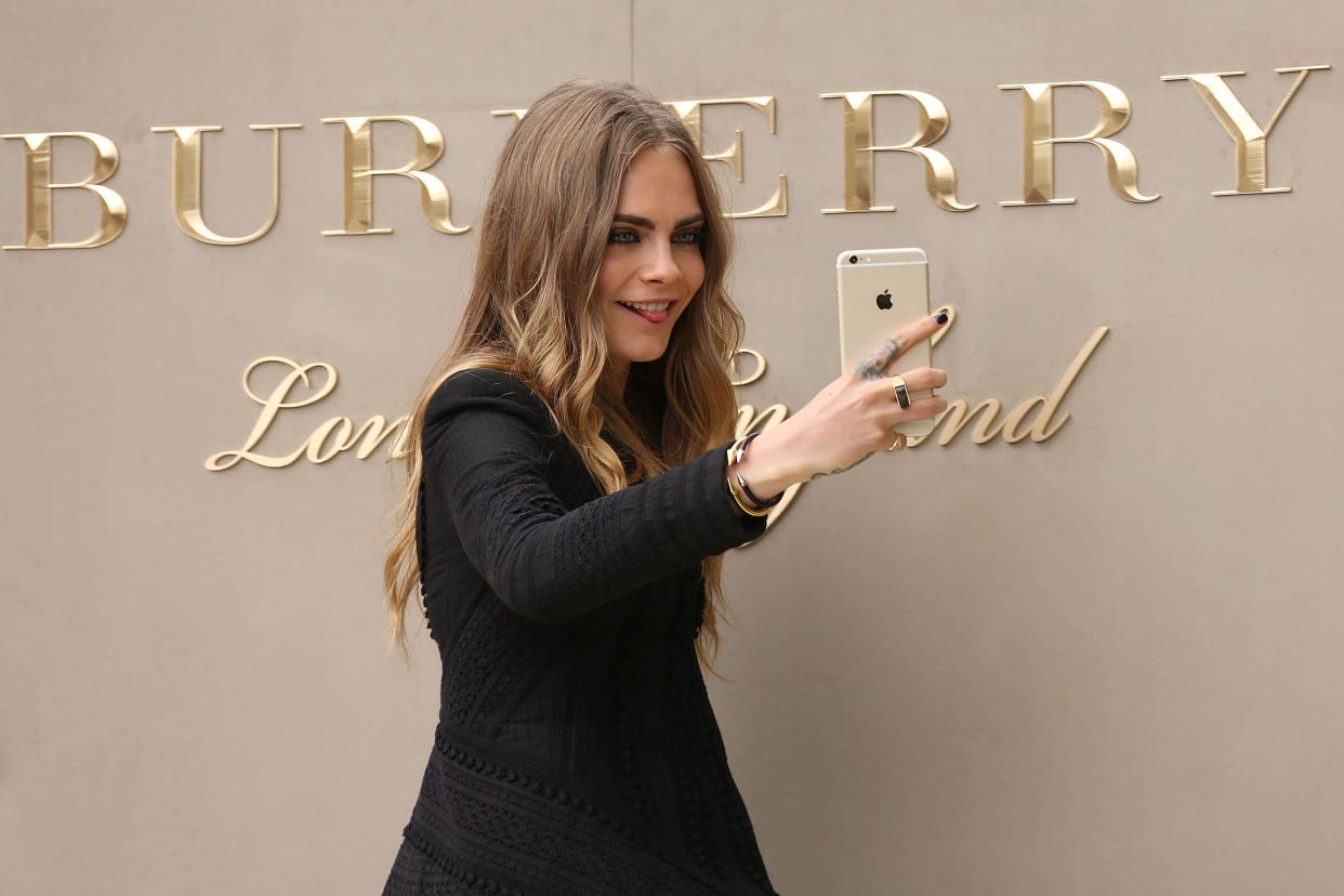 Luxury goods brand Burberry presents results this Wednesday. Above, British model Cara Delevingne poses for a selfie as she arrives for the Burberry Prorsum Womenswear SS16 show in Kensington Gore, west London. 