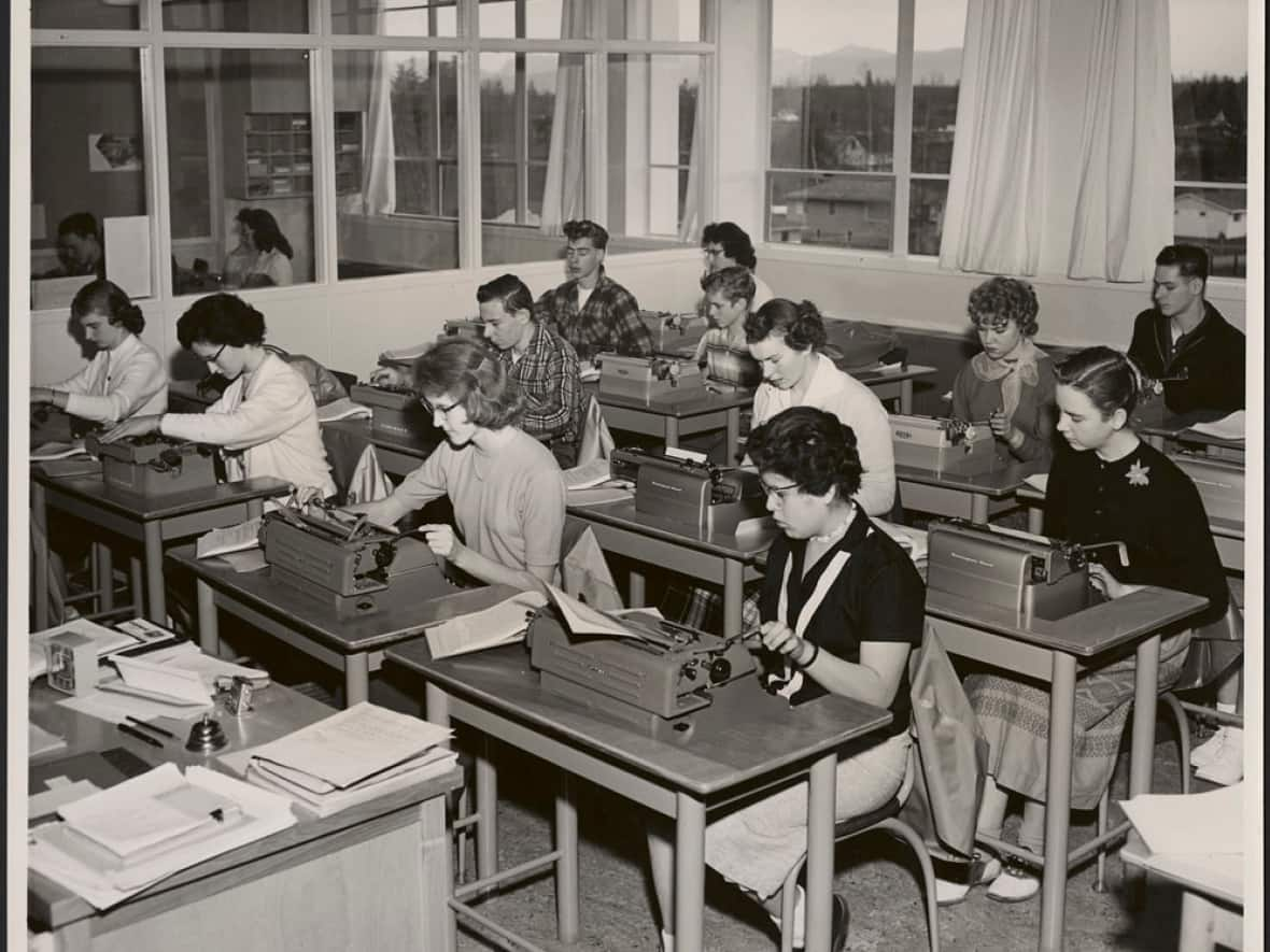 Lorraine Carpenter, right foreground, from Heiltsuk Nation (formerly Bella Bella Band), Campbell Island, B.C., studying secretarial work at Aldergrove high school in an undated archival photo. She was among eight First Nations students boarded in non-Indigenous homes in the school's district. (Canada. Dept. of Manpower and Immigration/Library and Archives Canada - image credit)