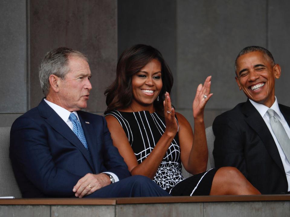 Former President George W. Bush, left, sits with President Barack Obama, right, and first lady Michelle Obama, center, at the dedication ceremony for the Smithsonian Museum of African American History and Culture on the National Mall in Washington, Saturday, Sept. 24, 2016.