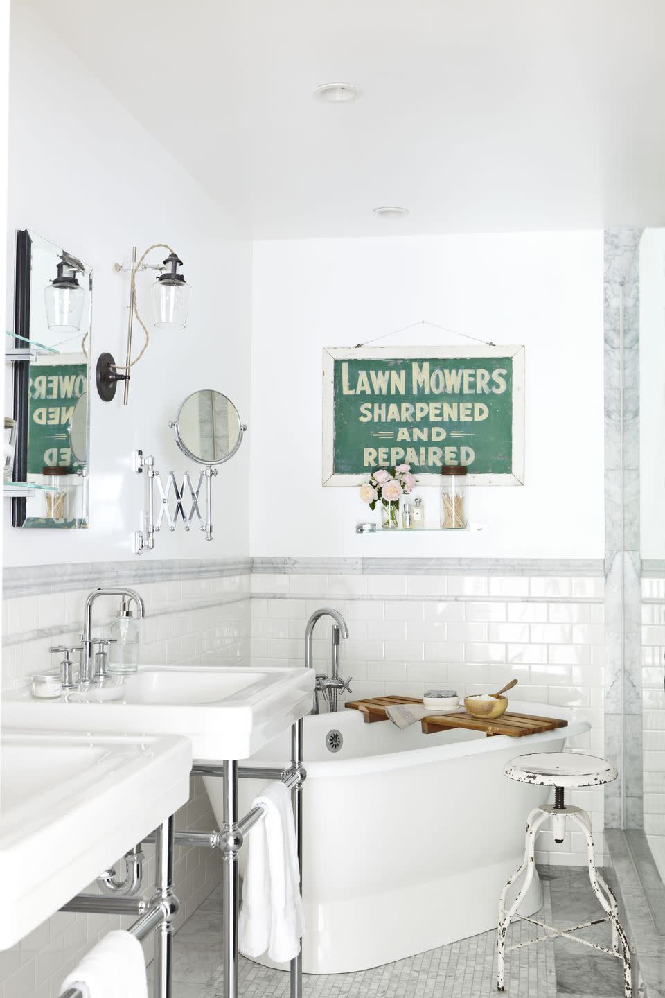 a white bathroom with a tub sink and mirror