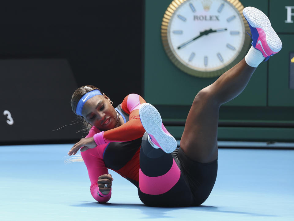 United States' Serena Williams falls during her fourth round match against Aryna Sabalenka of Belarus at the Australian Open tennis championship in Melbourne, Australia, Sunday, Feb. 14, 2021.(AP Photo/Hamish Blair)