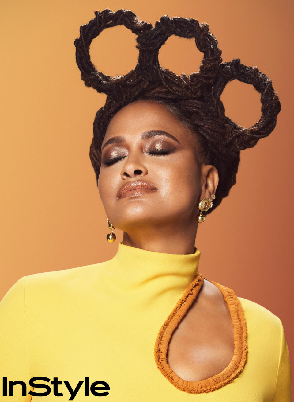 Ava DuVernay shares how significant it was to stop straightening her hair with chemicals and embrace her natural curly locs. (Courtesy Chrisean Rose / InStyle)