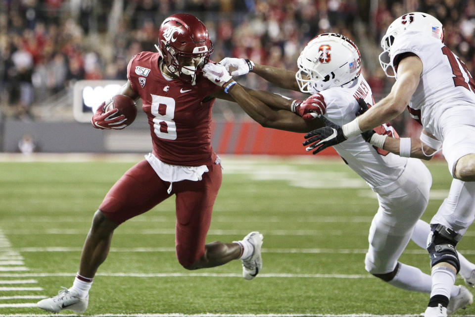 Washington State wide receiver Easop Winston Jr., left, carries the ball while pressured by Stanford cornerback Zahran Manley, center, and safety Stuart Head during the second half of an NCAA college football game in Pullman, Wash., Saturday, Nov. 16, 2019. Washington State won 49-22. (AP Photo/Young Kwak)