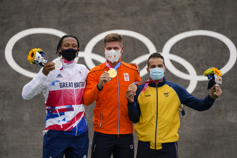 Niek Kimmann of the Netherlands, center, Kye Whyte of Britain, left, and Carlos Alberto Ramirez Yepes of Colombia, right, stand with their medals in the men's BMX Racing finals at the 2020 Summer Olympics, Friday, July 30, 2021, in Tokyo, Japan. (AP Photo/Ben Curtis)