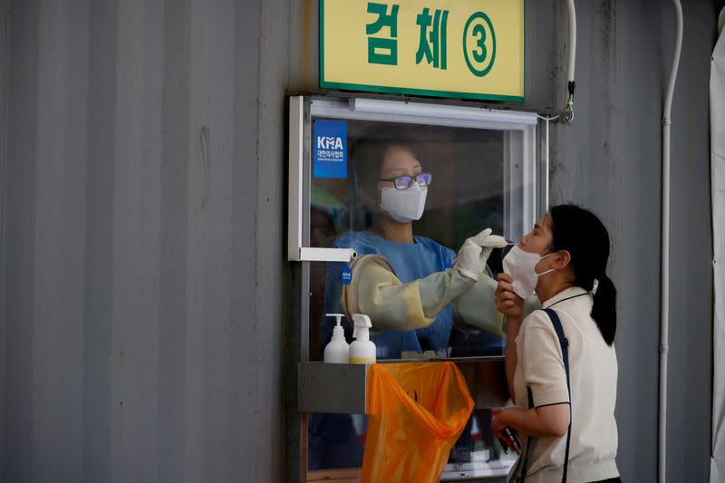 FILE PHOTO: FILE PHOTO: A woman gets a coronavirus disease (COVID-19) test at a coronavirus testing site in Seoul