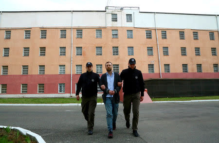 Jack Shepherd, who went on the run last year after killing a woman in a speedboat crash on the River Thames, is escorted during his extradition in Tbilisi, Georgia April 10, 2019. The Ministry of Internal Affairs of Georgia/Handout via REUTERS