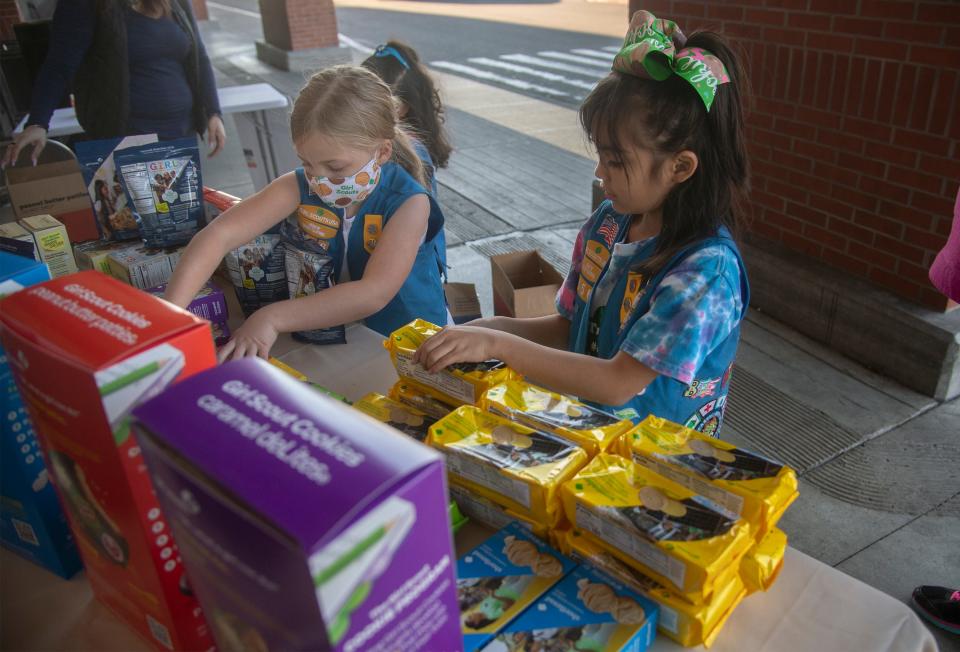 (2/25/22)Seven-year-old Daisy Girl Scouts Colleen Bunag from Troop 656, left, and Aaiyah Garcia arrange boxes of Girls Scout cookies during site sales in front of the Safeway on Country Club   CLIFFORD OTO/THE STOCKTON RECORD