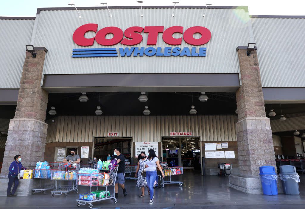 Shoppers walk in front of a Costco store