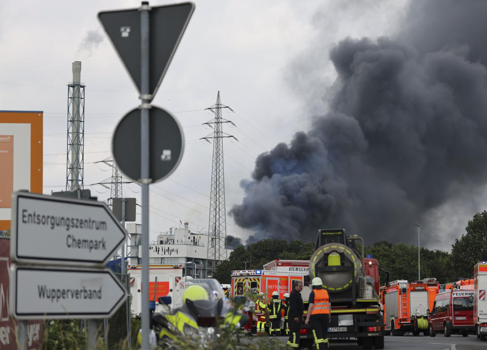 A dark cloud of smoke rises above the Chempark in Leverkusen, Germany, Tuesday, July 27, 2021. After an explosion, fire brigade, rescue forces and police are currently in large-scale operation, the police explained.(Oliver Berg/dpa via AP)