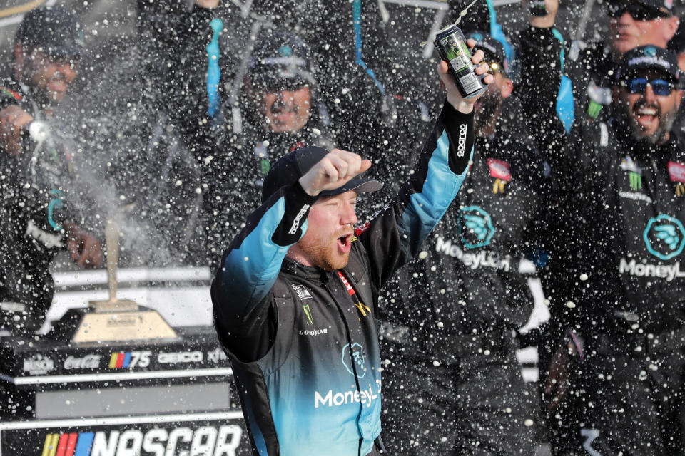 Tyler Reddick celebrates in Victory Lane after winning a NASCAR Cup Series auto race at Kansas Speedway in Kansas City, Kan., Sunday, Sept. 10, 2023. (AP Photo/Colin E. Braley)