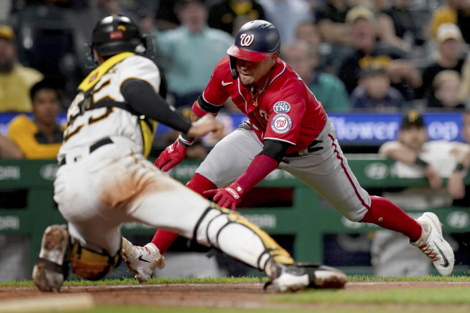 Pittsburgh Pirates catcher Endy Rodriguez reaches to tag out Washington Nationals' Ildemaro Vargas at home plate during the seventh inning of a baseball game in Pittsburgh, Tuesday, Sept. 12, 2023. (AP Photo/Matt Freed)