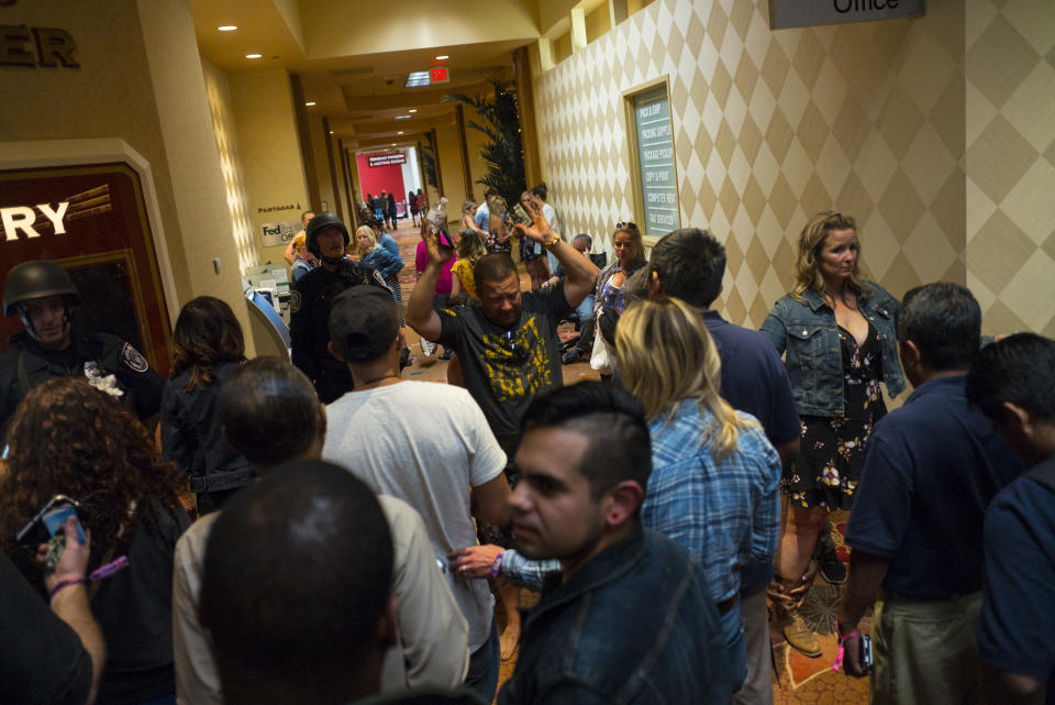 <p>People are searched by Las Vegas police at the Tropicana Las Vegas during an active shooter situation on the Las Vegas Strip on Sunday, Oct. 1, 2017. (Photo: Chase Stevens/Las Vegas Review-Journal via AP) </p>