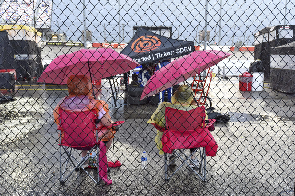 NASCAR fans wait out a rain delay before the start of a NASCAR Cup Series auto race on Sunday, Sept. 1, 2019, at Darlington Raceway in Darlington, S.C. (AP Photo/Richard Shiro)