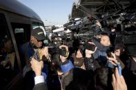 Former NBA star Dennis Rodman, left, arrives at the capital airport for a flight to North Korea, in Beijing, China, Thursday, Dec. 19, 2013. Rodman is flying to North Korea to help train the national team and renew his friendship with the North’s young leader Kim Jong Un, a visit unaffected by the recent execution of Kim’s uncle in a dramatic political purge. (AP Photo/Ng Han Guan)