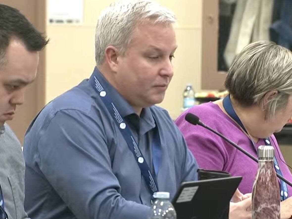 Spencer Dewar, centre, director of resource management for Crown-Indigenous Relations and Northern Affairs Canada, listens to critical questions from community members Tuesday at the Nunavut draft land use plan hearings in Thompson, Man. (CBC - image credit)