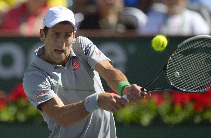 Novak Djokovic, of Serbia, hits to Julien Benneteau, of France, in their quarterfinal match at the BNP Paribas Open tennis tournament on Friday, March 14, 2014, in Indian Wells, Calif. (AP Photo/Mark J. Terrill)