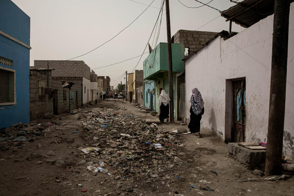 In this July 20, 2019 photo, Ethiopian migrant women walk through the Basateen area of Aden, Yemen. Many migrants languish for months in the slums of Basateen, a district that was once a green area of gardens but now is covered in decrepit shacks of cinder blocks, concrete, tin and tarps, amid open sewers. (AP Photo/Nariman El-Mofty)