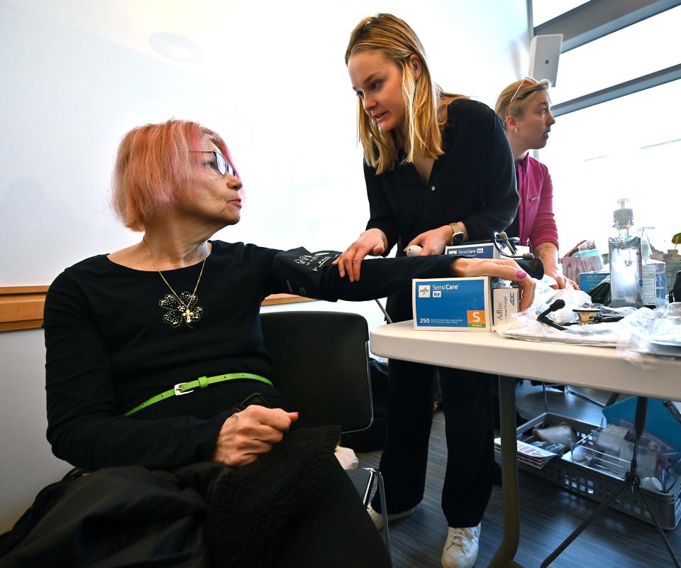 Kathleen Ryan Trumpaitis, 71, of Worcester has her blood pressure taken by first-year medical student Janelle Renterghem of Medford at the Worcester Community Midwifery table.