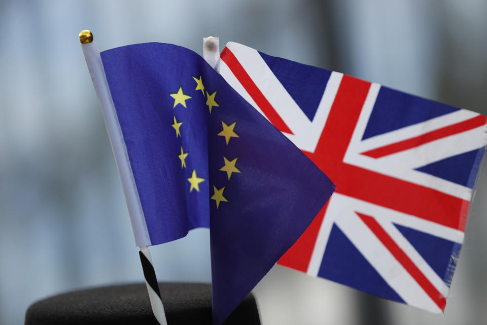 A protestor wears a hat with an EU and a Union flag as he participates in an anti-Brexit demonstration outside of an EU summit in Brussels, Thursday, Oct. 17, 2019. The European Union says Brexit negotiations are plowing on after intense talks in recent days, as EU leaders converge on Brussels for a key summit aimed at sealing a new divorce agreement. (AP Photo/Frank Augstein)