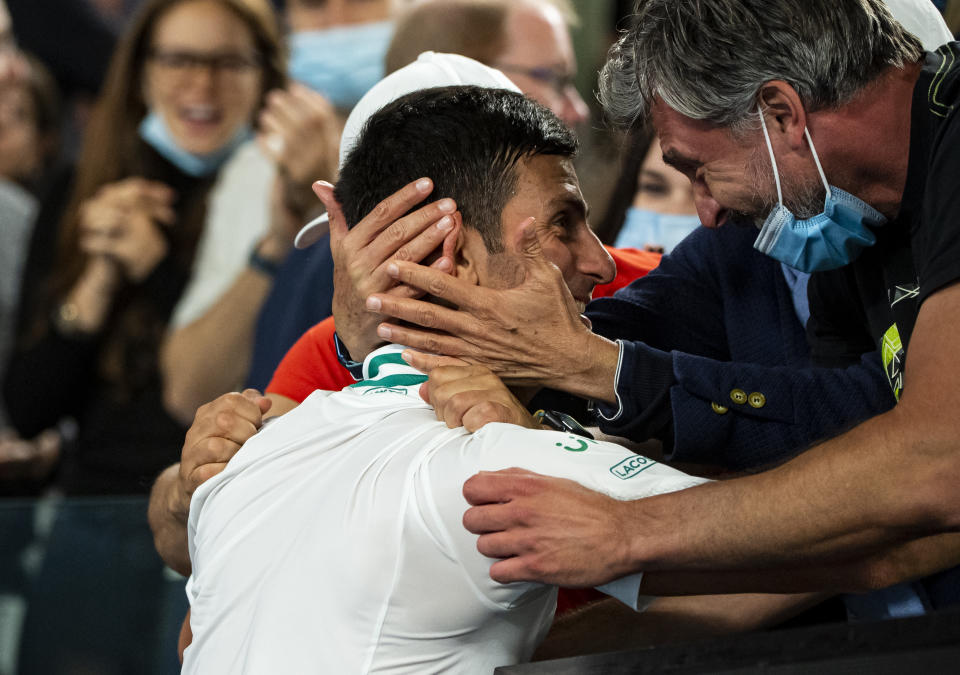 Novak Djokovic  celebrates with his team after beating Daniil Medvedev of Russia in the men's singles final  during day 14 of the 2021 Australian Open at Melbourne Park on February 21, 2021 in Melbourne, Australia.