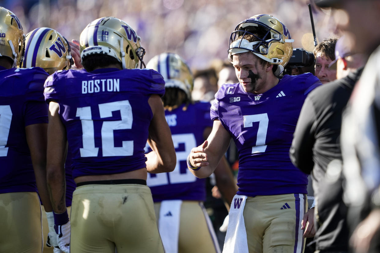 Washington quarterback Will Rogers (7) greets wide receiver Denzel Boston (12) after throwing a touchdown pass to Boston during the first half of an NCAA college football game against Northwestern, Saturday, Sept. 21, 2024, in Seattle. (AP Photo/Lindsey Wasson)