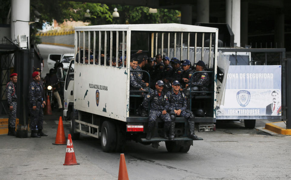 National Police enter the Helicoide prison in Caracas, Venezuela, Thursday, May 9, 2019, where Edgar Zambrano, vice president of the opposition-controlled National Assembly is being held after his arrest the previous night. The arrest of Zambrano unleashed fears of a wider crackdown on Thursday, even as members of the opposition issued renewed calls for weekend protests in a months long campaign to oust President Nicolás Maduro. (AP Photo/Fernando Llano)