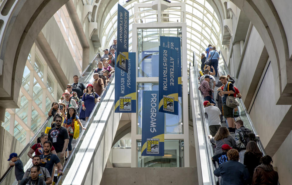 FILE - Attendees filter through the San Diego Convention Center on Day One at Comic-Con International on July 18, 2019, in San Diego, Calif. The convention will remain virtual for the July event, but organizers are planning for a smaller-scale gathering later this year. Comic-Con announced Monday, March 1, 2021, that the annual confab will return to virtual for a second-straight year between July 23-25. (Photo by Christy Radecic/Invision/AP, File)