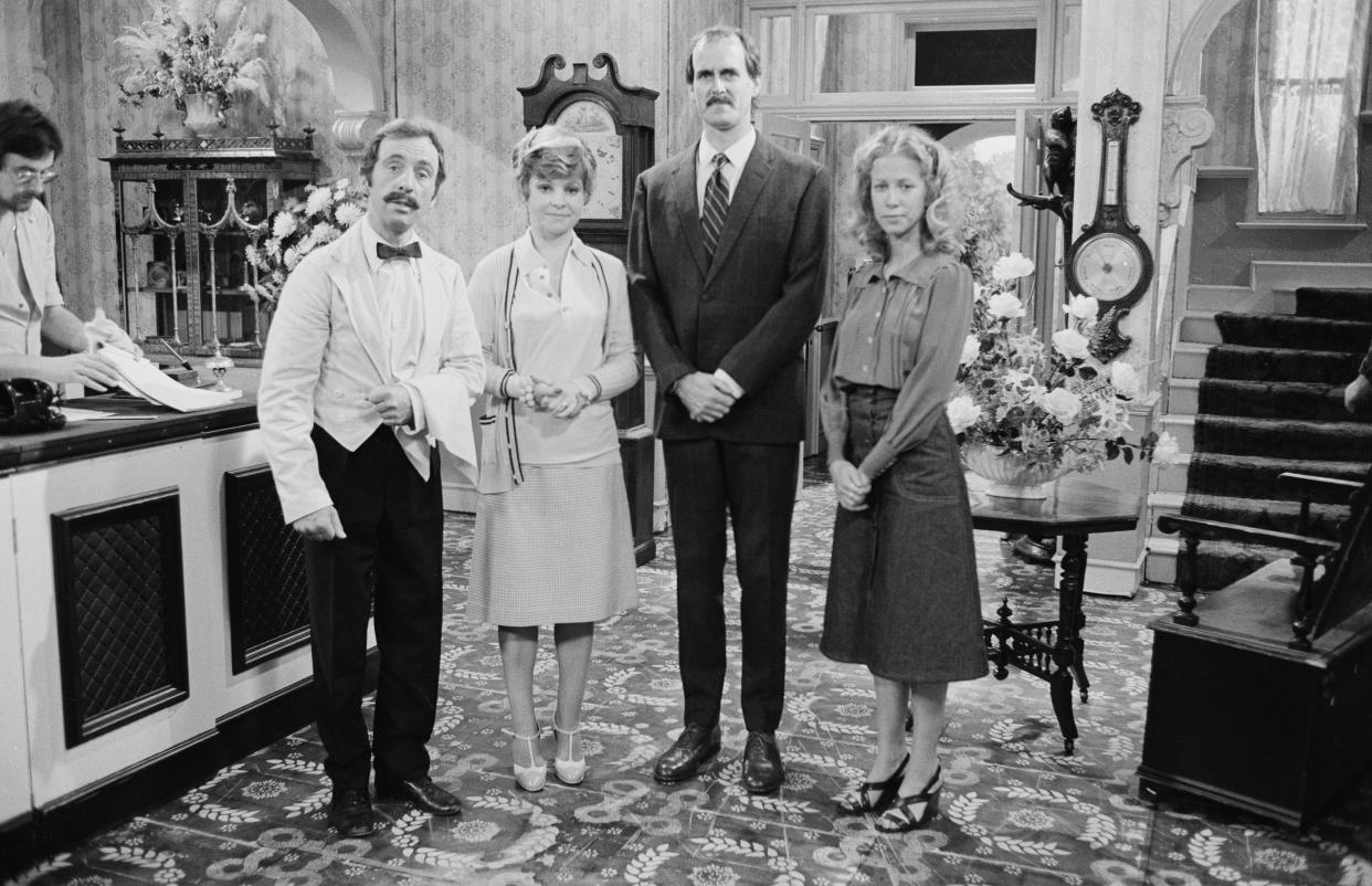 Actors (L-R) Andrew Sachs, Prunella Scales, John Cleese, Connie Booth on the set of the BBC television sitcom 'Fawlty Towers', August 3rd 1975. (Photo by Don Smith/Radio Times via Getty Images)