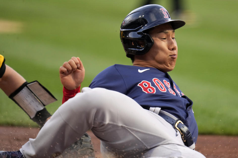 Boston Red Sox's Masataka Yoshida, right, is tagged out by Pittsburgh Pirates catcher Henry Davis while attempting to score from first on a double by Bobby Dalbec off Pittsburgh Pirates starting pitcher Quinn Priester during the second inning of a baseball game in Pittsburgh, Friday, April 19, 2024. (AP Photo/Gene J. Puskar)