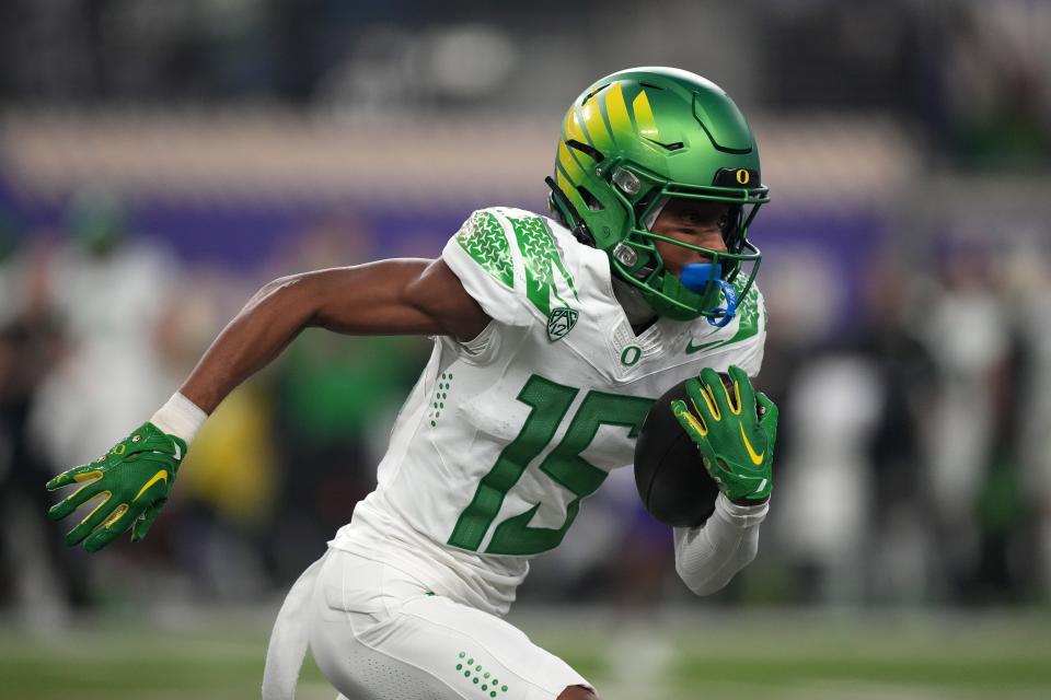 Oregon Ducks wide receiver Tez Johnson (15) carries the ball against the Washington Huskies in the first half at Allegiant Stadium Dec. 1 in Las Vegas.