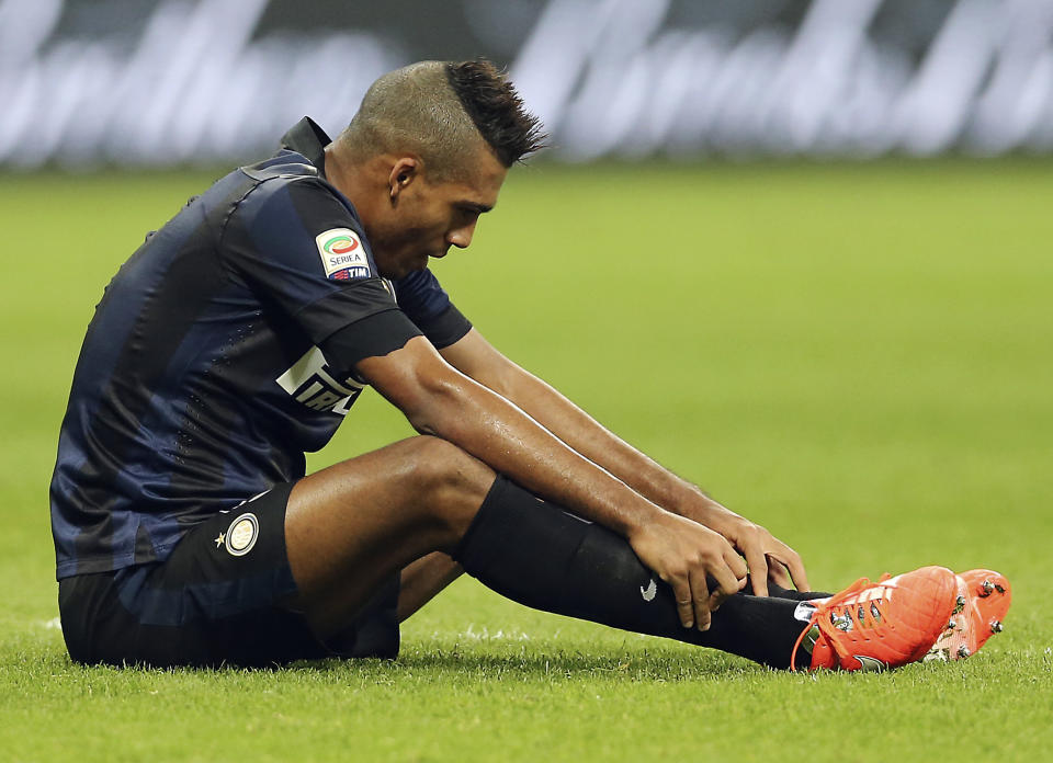 Inter Milan Brazilian defender Juan Jesus sits on the field at the end of the Serie A soccer match between Inter Milan and Udinese at the San Siro stadium in Milan, Italy, Thursday, March 27, 2014. The match ended in a scoreless draw. (AP Photo/Antonio Calanni)