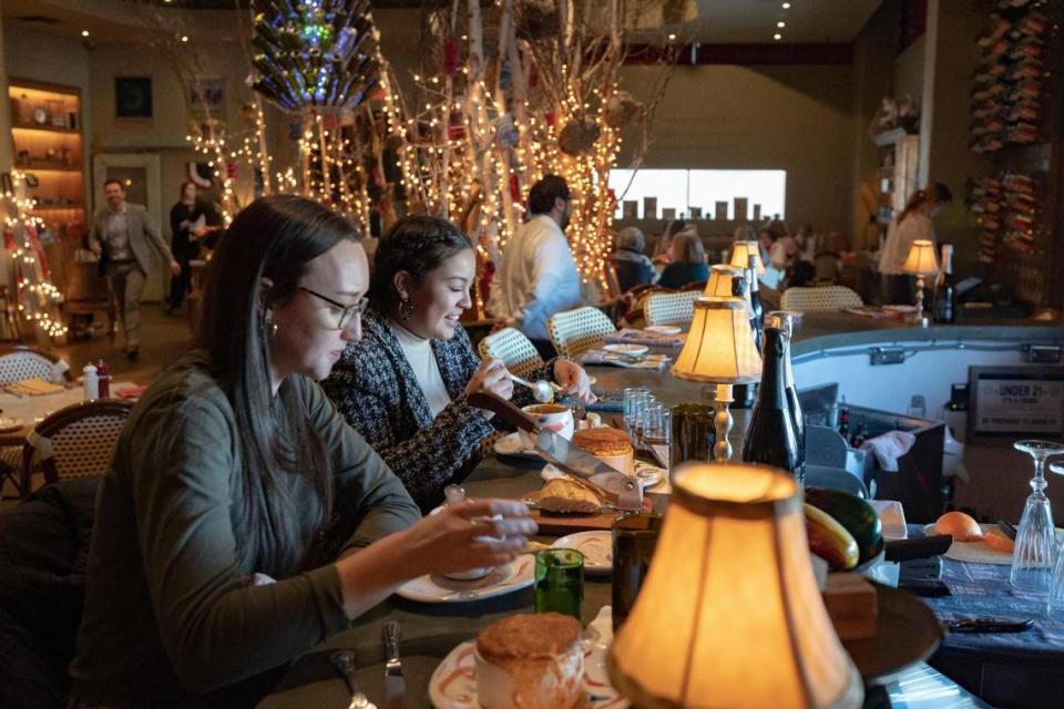 Diners Madison Mahan and Jasmine Cabrera enjoy a salmon and crab soufflé at Rise, a French cafe at The Shops at Clearfork in Fort Worth on Friday, Jan. 27, 2023.