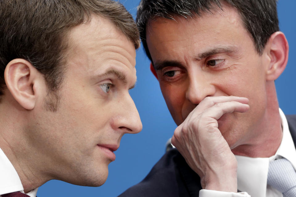 FILE - In this April 8, 2015 file photo, then French prime minister Manuel Valls, right, speaks with then economy minister Macron during in Paris. French centrist presidential hopeful Emmanuel Macron has won the backing of Socialist former prime minister Manuel Valls. (AP Photo/Philippe Wojazer/Pool, File)
