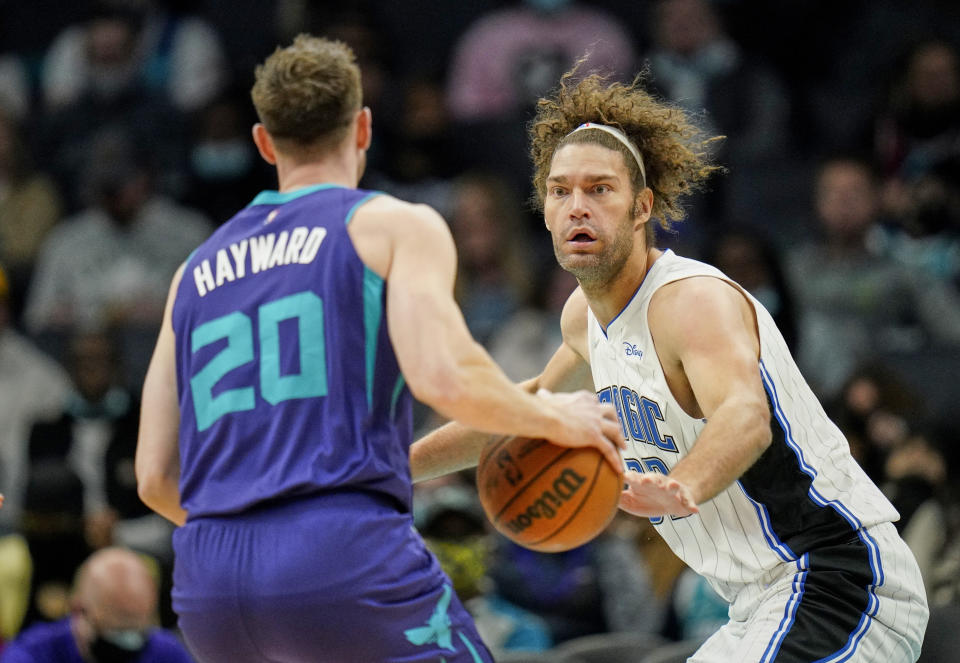 Orlando Magic center Robin Lopez (33) guards Charlotte Hornets forward Gordon Hayward (20) during the first half of an NBA basketball game on Friday, Jan. 14, 2022, in Charlotte, N.C. (AP Photo/Rusty Jones)