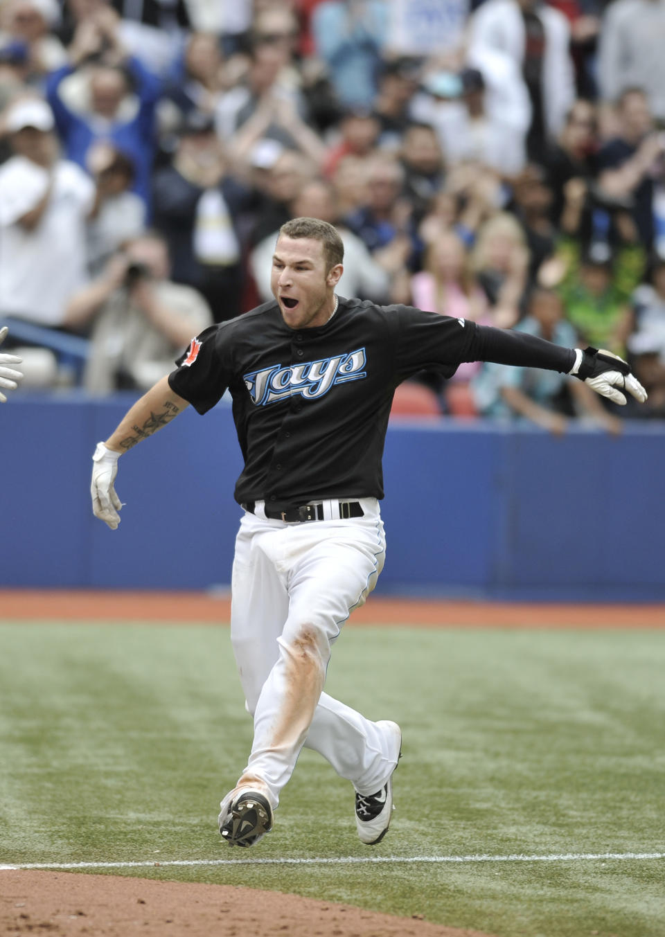 TORONTO, CANADA - SEPTEMBER 05: Brett Lawrie #13 of the Toronto Blue Jays celebrates his bottom of the 11th inning walk off home run during MLB game action against the Boston Red Sox September 5, 2011 at Rogers Centre in Toronto, Ontario, Canada. (Photo by Brad White/Getty Images)
