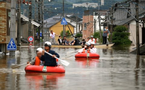 Isolated residents are being rescued from their homes - Credit: The Asahi Shimbun via Getty Images