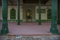 A pair of shoes sits near an outdoor prayer area at the Id Kah Mosque in Kashgar in western China's Xinjiang Uyghur Autonomous Region, as seen during a government organized visit for foreign journalists on April 19, 2021. Under the weight of official policies, the future of Islam appears precarious in Xinjiang, a remote region facing Central Asia in China's northwest corner. Outside observers say scores of mosques have been demolished, which Beijing denies, and locals say the number of worshippers is on the decline. (AP Photo/Mark Schiefelbein)