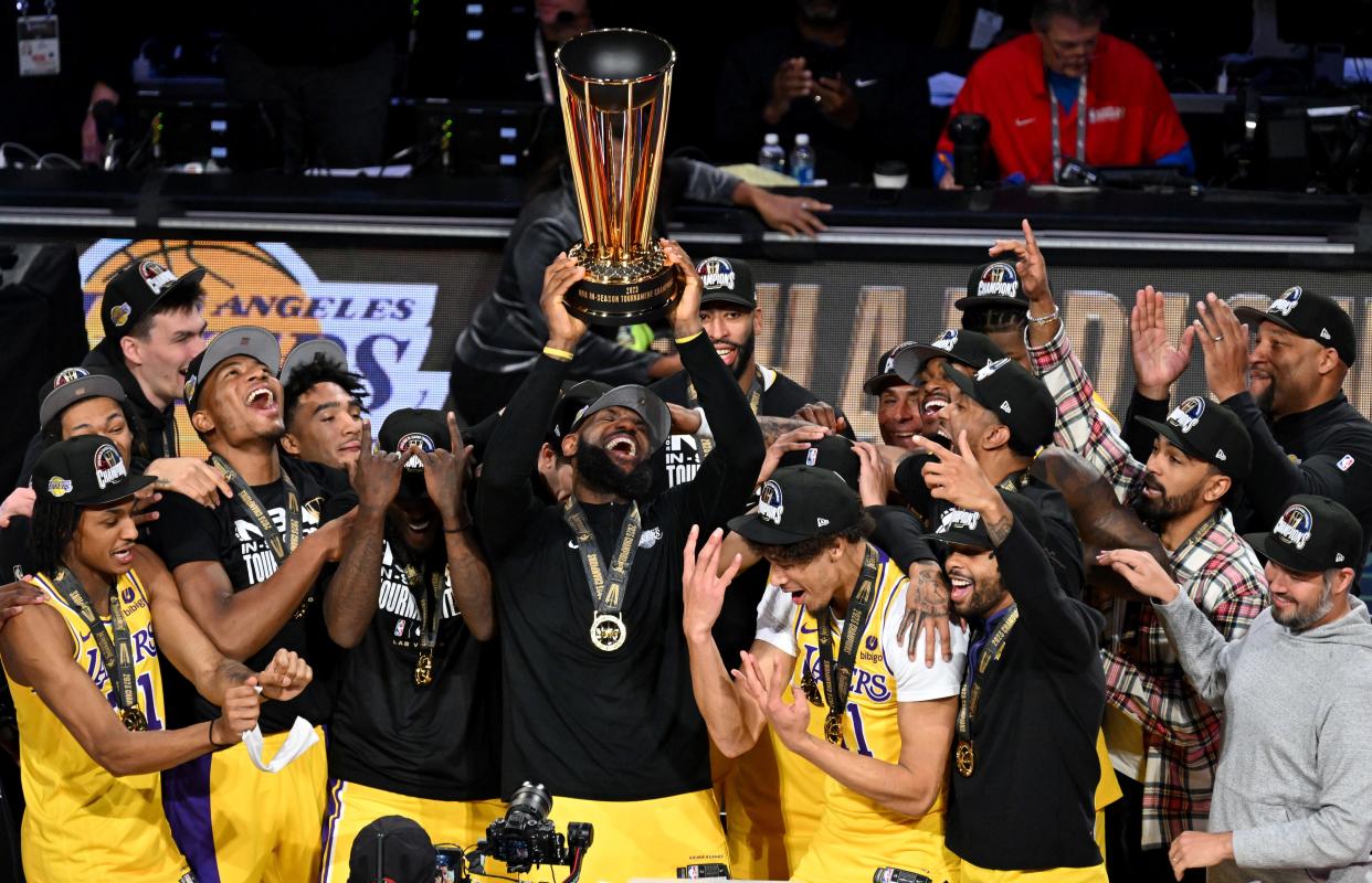LeBron James lifts the NBA Cup after the Lakers defeated the Pacers to win the NBA In-Season Tournament.