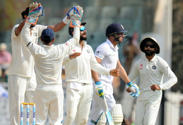 India's captain Virat Kohli (C) and teammates celebrate after the dismissal of England's Jos Buttler during the second day of their fifth and final Test match on December 17, 2016