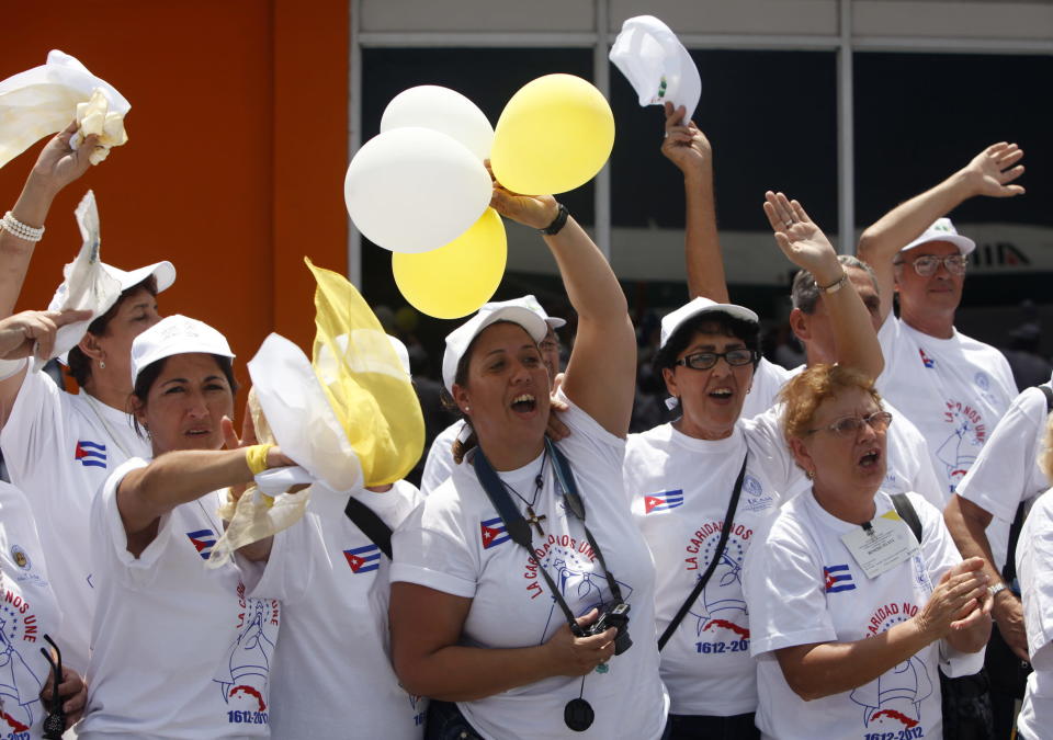 Un grupo de fieles celebra la llegada del papa Benedicto XVI este 27 de marzo de 2012, al aeropuerto José Martí de la ciudad de La Habana, procedente de Santiago de Cuba. El pontÌfice llegó este mediodía a la capital de la isla, el segundo escenario de su visita a Cuba, donde se reunirá con el presidente Raúl Castro y oficiará, el miércoles, una misa en la Plaza de la Revolución. EFE/ David Fernández