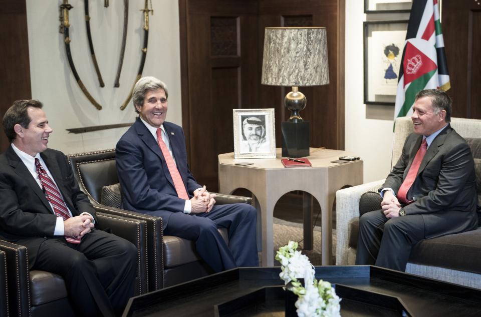 U.S. Ambassador to Jordan Stuart E. Jones, left, Jordan's King Abdullah II, right, and U.S. Secretary of State John Kerry talk before attending a meeting at al-Hummar Palace in Amman on Sunday, Jan. 5, 2014. America's top diplomat is trying to nudge Israel and the Palestinians closer to signing an accord, setting up a Palestinian state alongside Israel. Kerry said Saturday that progress is being made, yet key hurdles are yet to be overcome. Kerry's talks on Sunday with Jordan's King Abdullah II and Saudi Arabia's King Abdullah are likely to also touch on the war in Syria, rising violence in Iraq, and Iran's nuclear program. (AP Photo/Brendan Smialowski, Pool)