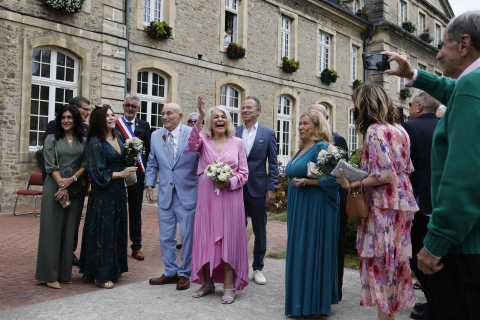 US WWII veteran Harold Terens, 100, center left, and Jeanne Swerlin, 96, arrive to celebrate their wedding at the town hall of Carentan-les-Marais, in Normandy, northwestern France, on Saturday, June 8, 2024. Together, the collective age of the bride and groom was nearly 200. But Terens and his sweetheart Jeanne Swerlin proved that love is eternal as they tied the knot Saturday inland of the D-Day beaches in Normandy, France. (AP Photo/Jeremias Gonzalez)