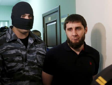 FILE PHOTO: Zaur Dadayev, who is suspected of involvement in the killing of opposition figure Boris Nemtsov, is escorted inside a court building at the Moscow military district court, Russia October 3, 2016. REUTERS/Maxim Zmeyev/File Photo
