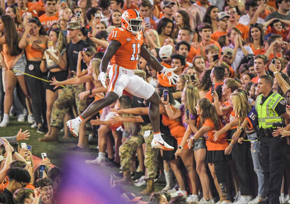 Clemson wide receiver Ajou Ajou (11) jumps up as he runs down the hill with the team, before the game with Boston College at Memorial Stadium in Clemson, S.C., October 2, 2021. 