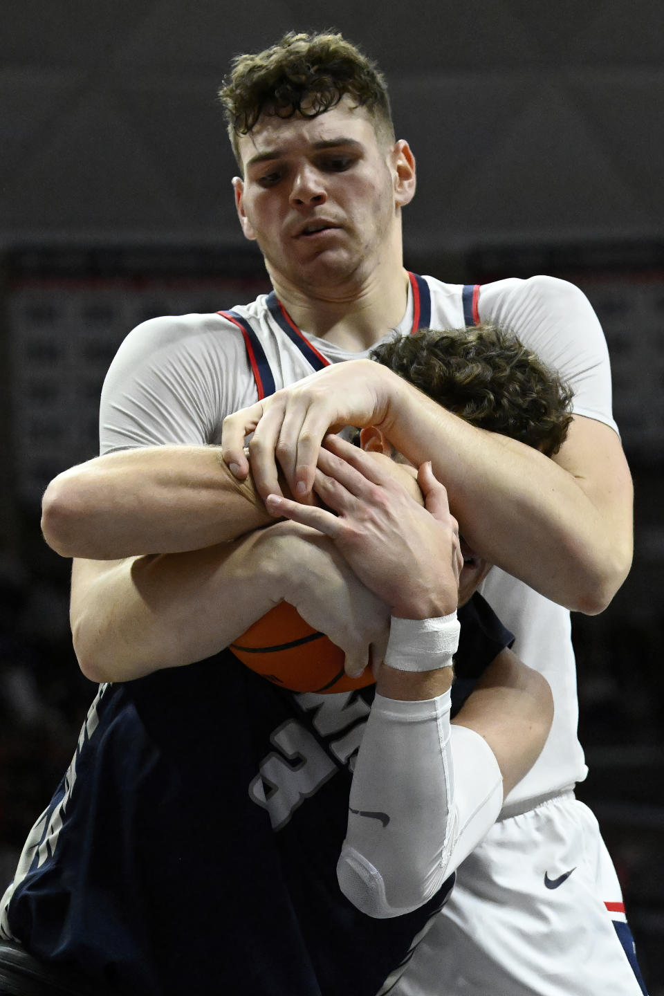 UConn center Donovan Clingan, top, and New Hampshire forward Jaxson Baker, bottom, fight for a rebound in the second half of an NCAA college basketball game, Monday, Nov. 27, 2023, in Storrs, Conn. (AP Photo/Jessica Hill)