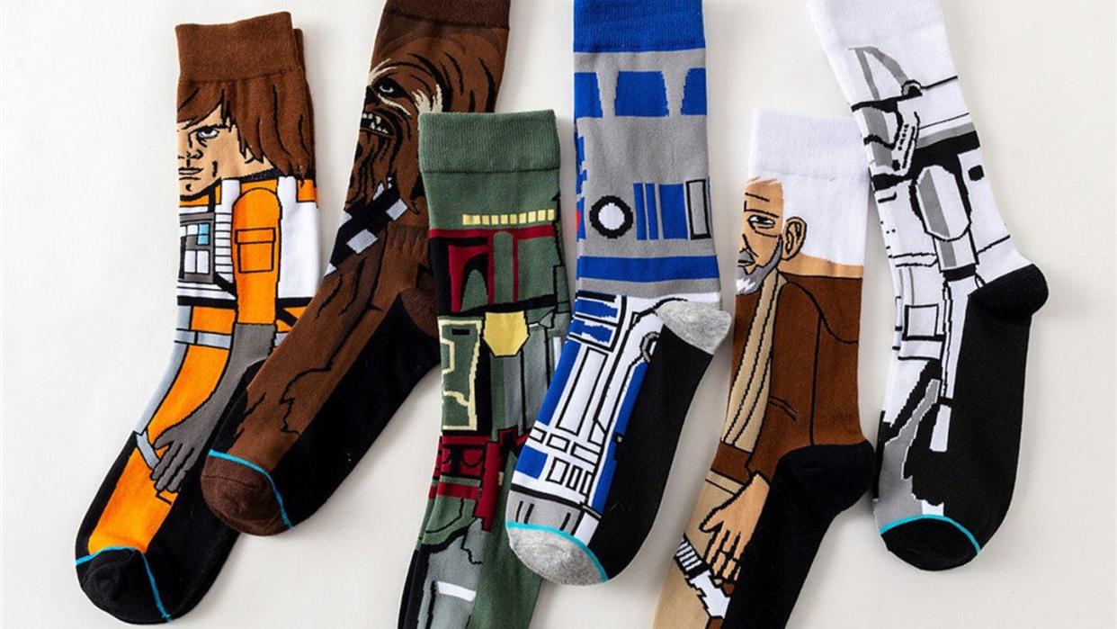 socks laying on white surface with star wars figures on them