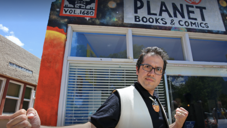 dr. inidiginerd in front of red planet books and comics