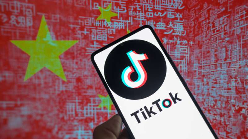 TikTok logo displayed on a smartphone and Chinese flag visible in background