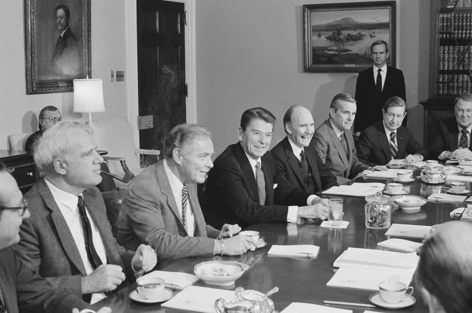 FILE - In this April 12, 1983 file photo, President Ronald Reagan chairs a session of his Commission on Strategic Forces, in the White House Cabinet Room in Washington. From left are: James Schlesinger, former Secretary of State Alexander M. Haig Jr., President Reagan and Brent Scowcroft, National Security adviser to President Ford and chairman of the panel. A longtime adviser to Presidents Gerald Ford and George H.W. Bush has died. Brent Scowcroft was 95. A spokesperson for the late President Bush says Scowcroft died Thursday of natural causes at his home in Falls Church, Virginia. (AP Photo/Charles Tasnadi)